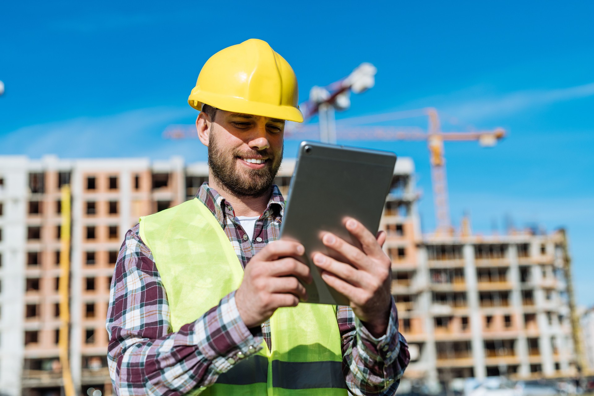 Construction worker or engineer using digital tablet